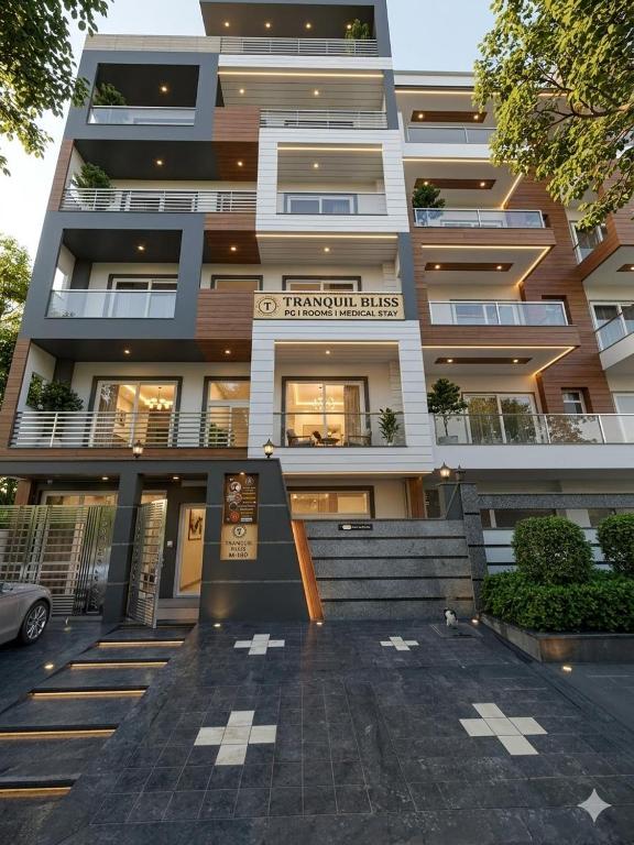 a large apartment building with stairs in front of it at Tranquil Bliss in Jāmb