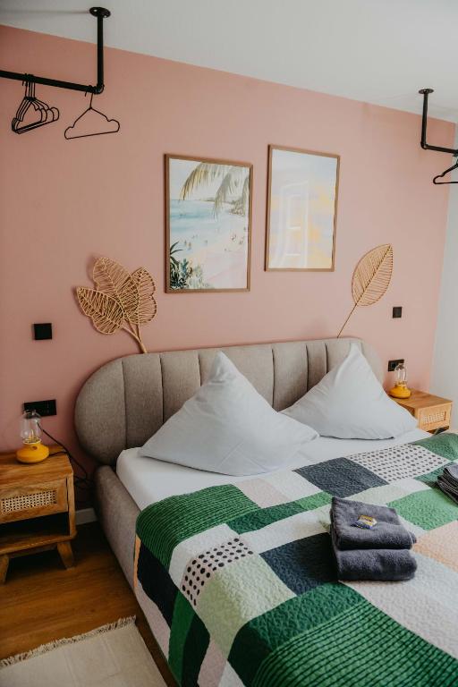 a bedroom with a bed with a blanket on it at sleepArt beach in Celle