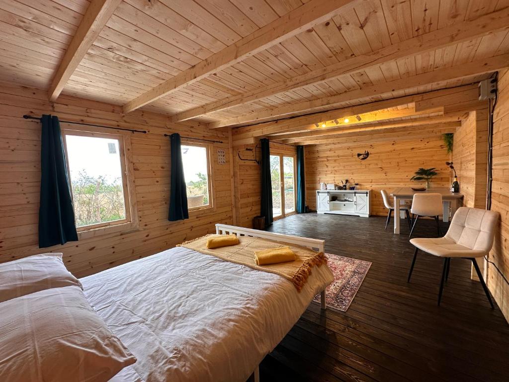 a bedroom with a large bed in a wooden room at Buzzard Holt Hosting in Buckingham