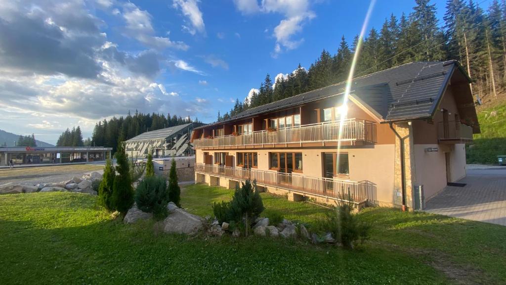 a house with a solarium on the side of it at Penzión JANÍK JASNÁ in Belá