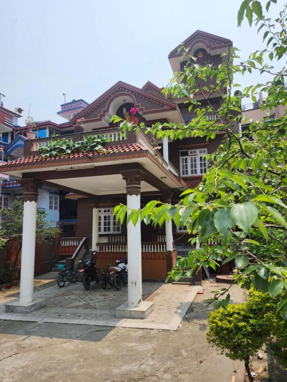 a large house with a pavilion in front of it at Om Raghav Homestay in Kathmandu