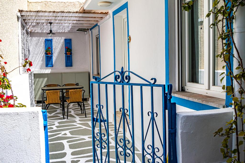 a blue and white door on a house with a table at Skiathos Pearl in Skiathos
