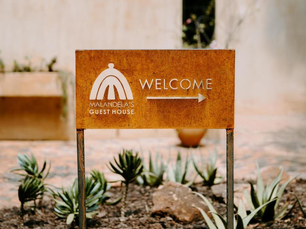 a welcome sign for a guest house at Malandela's Guest House in Malkerns