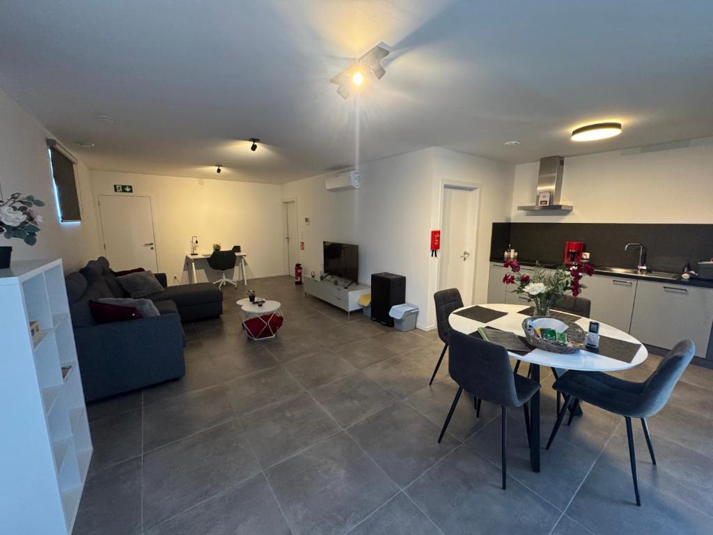 a living room with a table and a couch at 't Wellement in Denderleeuw