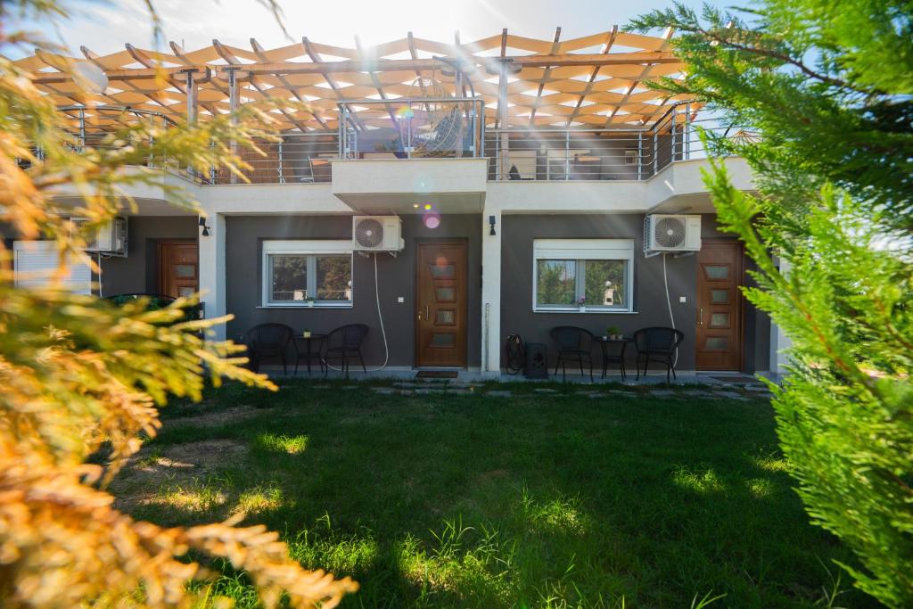 a house with a patio and a yard at Aegean View Summer House 1 in Nea Kallikrateia