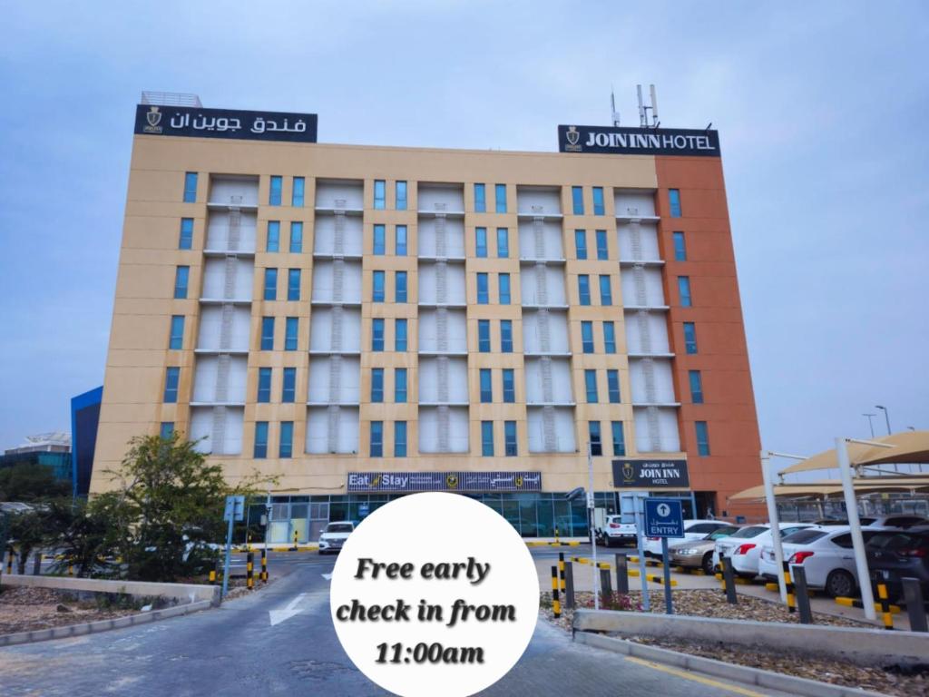 a hotel building with a free entry check in from ireland at JOIN INN HOTEL Jebel Ali, Dubai - Formerly easyHotel Jebel Ali in Dubai