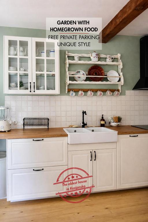 a kitchen with white cabinets and a sink at Cozy country home Stefka in Mokronog