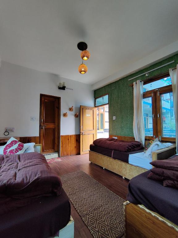 a bedroom with two beds and a window at The Bunker Burwa Manali in Manāli
