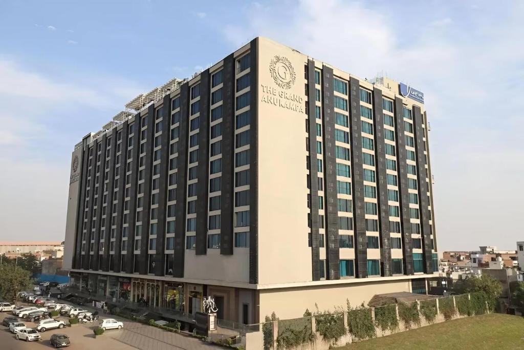 a large hotel building with a lot of windows at The Grand Anukampa in Jaipur