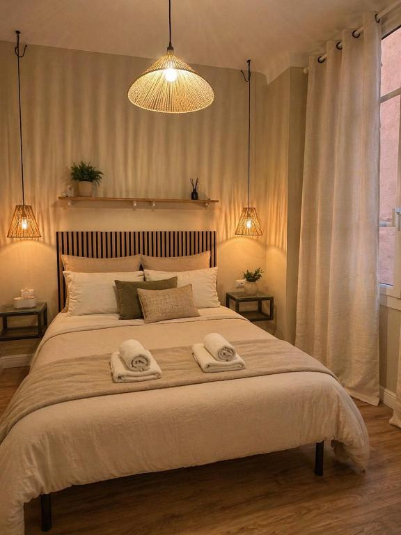 a bedroom with a large bed with two towels on it at Chambre Confort Premium - Monaco 1 in Beausoleil