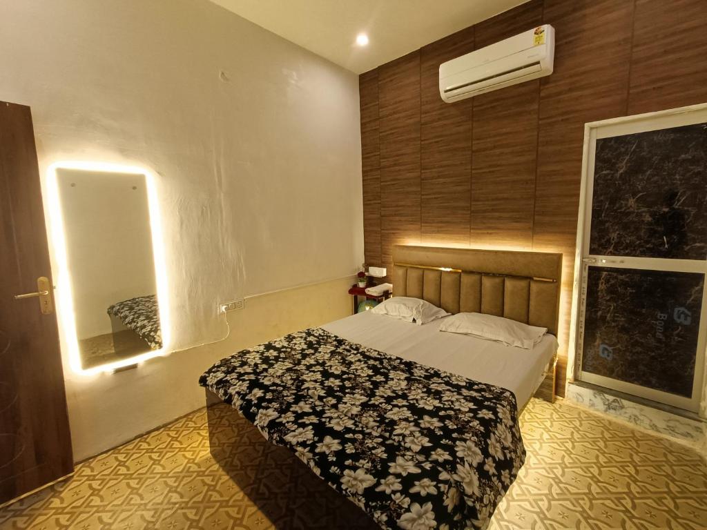 a bedroom with a bed and a window at Hotel Kalzug in Katihār