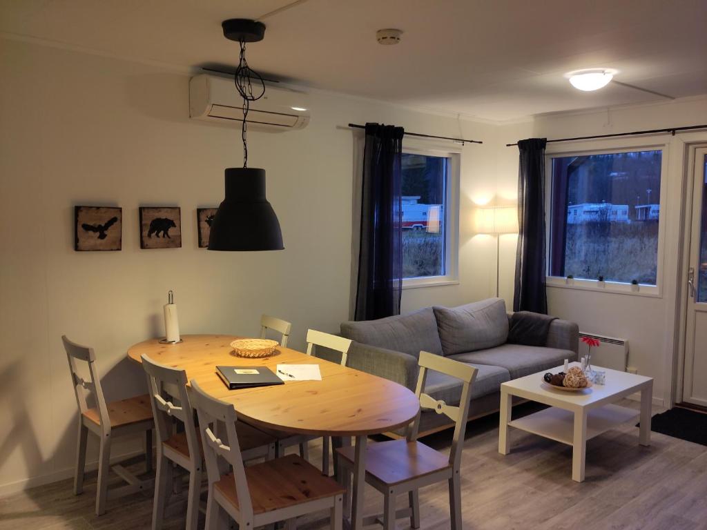 a living room with a table and a couch at Tärnaby Sportstugor in Tärnaby