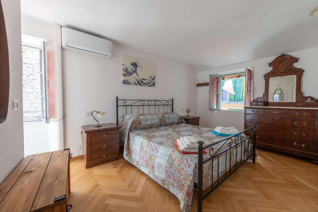 a bedroom with a bed and a dresser and a mirror at Casa Lia Family-Friendly Holiday Home in Sala Comacina
