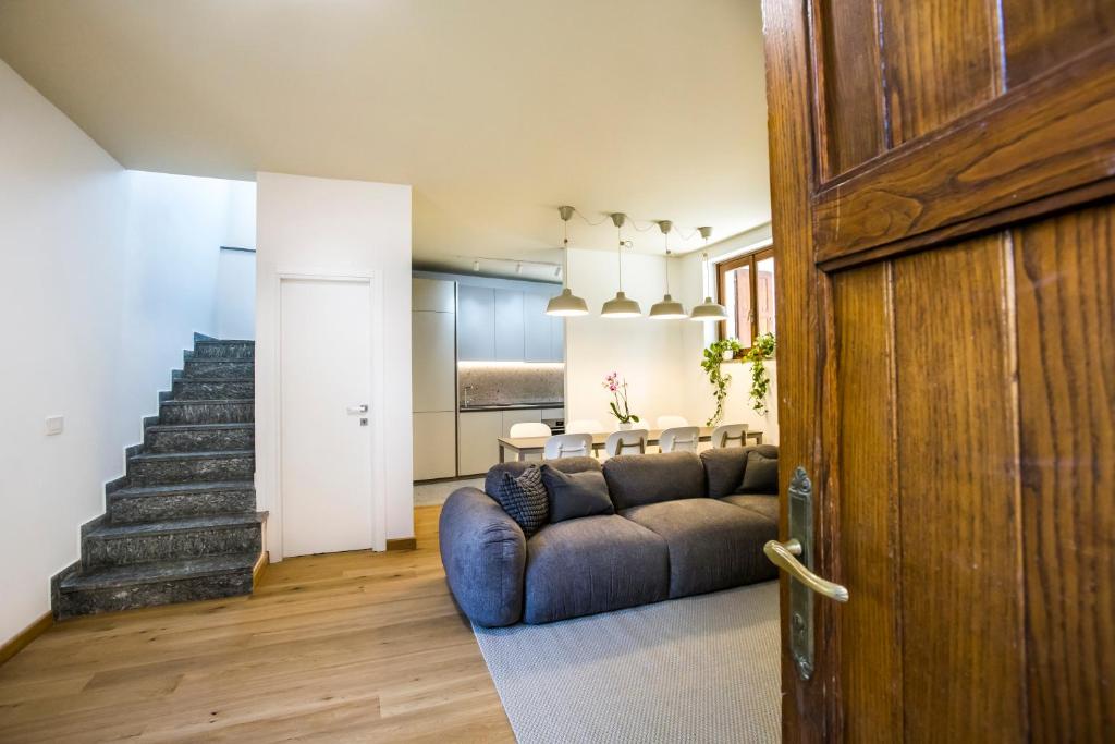 a living room with a couch and a staircase at La Ca di Nosee in Nesso