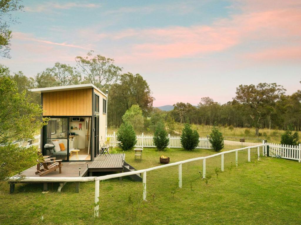 a tiny house on a deck in a yard at Yellow Rock Views by Tiny Away in Broke