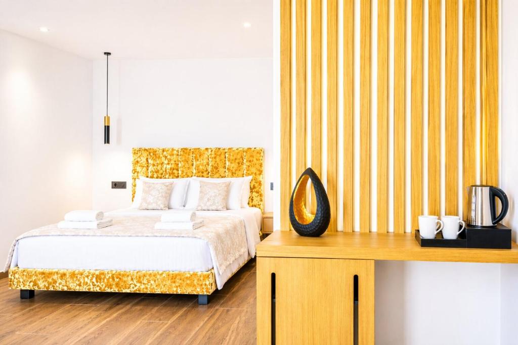 a bedroom with a bed and a yellow striped wall at Nobile Boutique Hotel in Agios Gordios