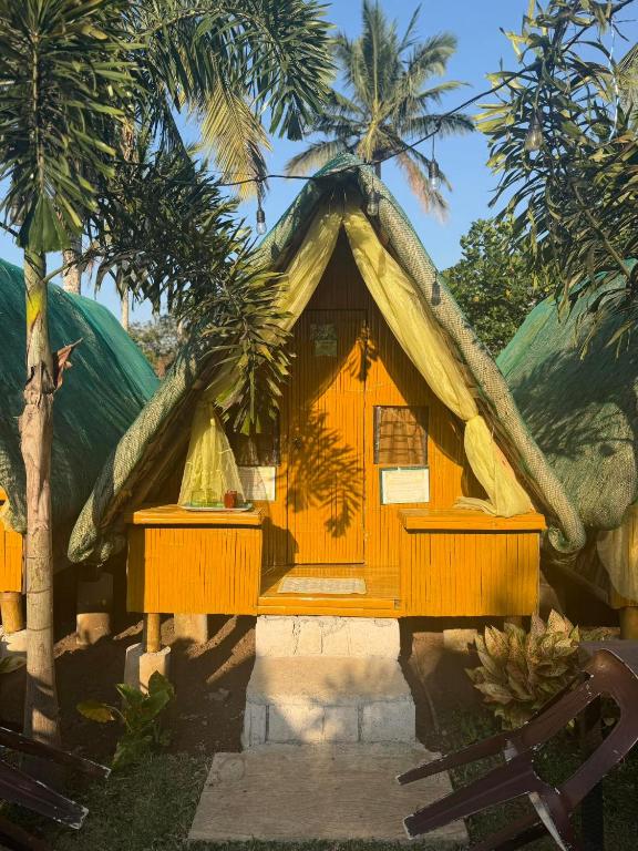 a small house with a thatched roof at Itawis Resort - Balai Angel in Silang