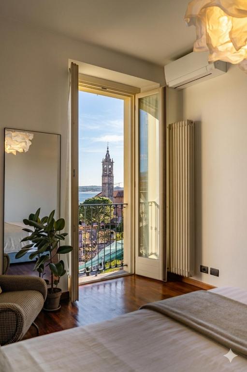a bedroom with a bed and a view of a building at Japo House - Like at your house in Pusiano
