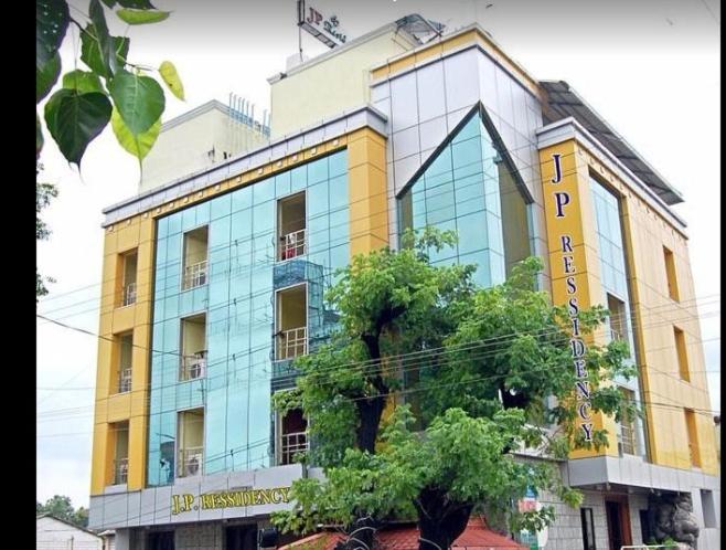 a building with a sign on the side of it at JPResidency in Pondicherry