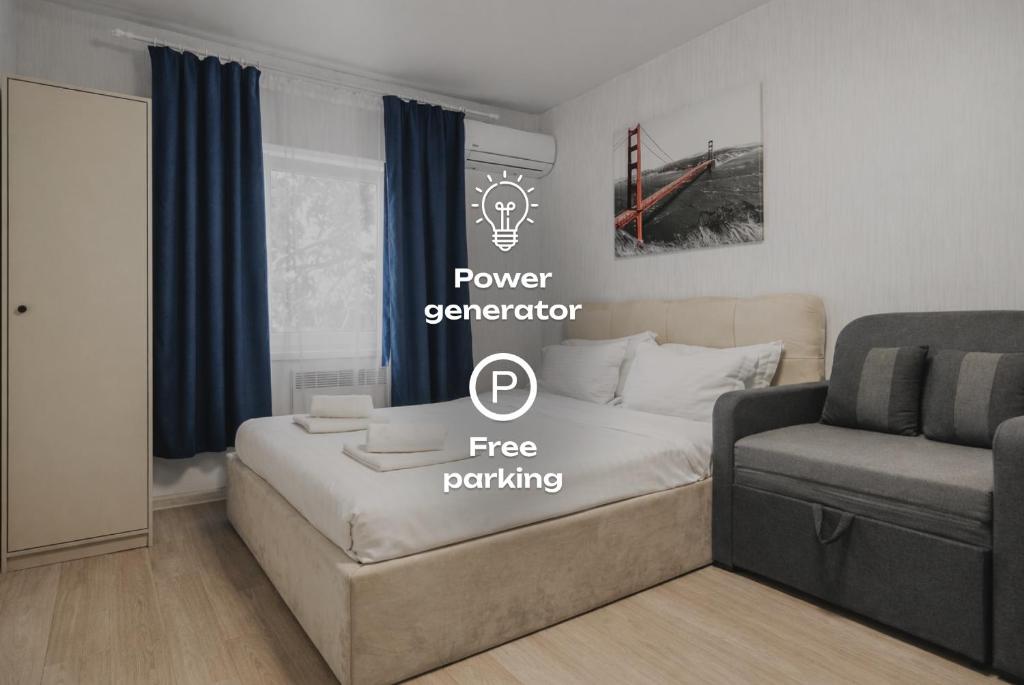 a bedroom with a bed and a couch and a chair at River House Apartments in Kyiv
