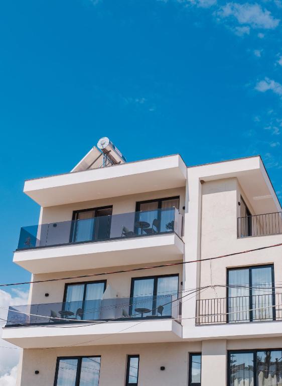 a building with a blue sky in the background at Hotel Parid in Ksamil