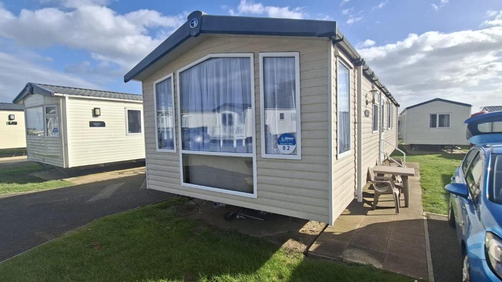 a tiny house is parked in a yard at Oystercatcher Hide, Chruch Farm in Pagham