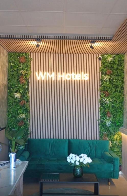 a living room with a green couch in a room at Hotel Schöne Altmark in Kalbe