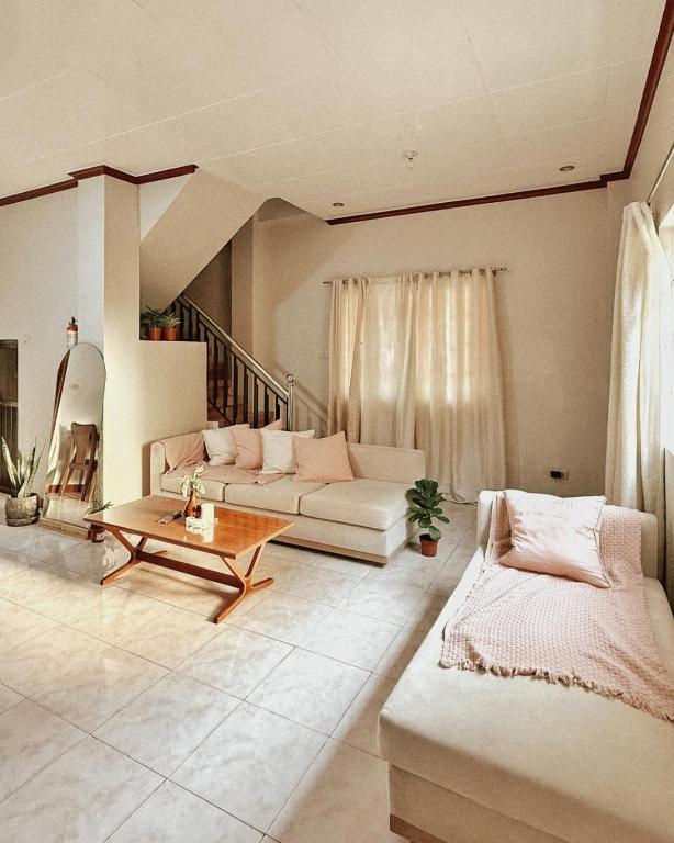 a living room with a couch and a table at Casa Clara La Union in Dalumpinas Oeste