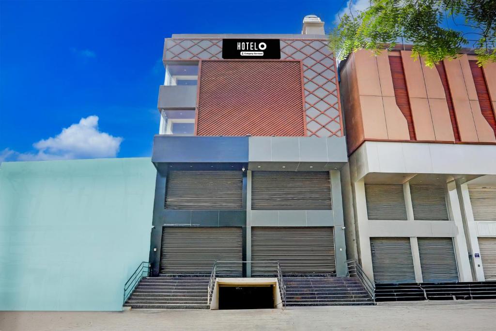 a building with doors and stairs in front of it at Super Hotel O Ananthpur Formerly TR Residency in Anantapur
