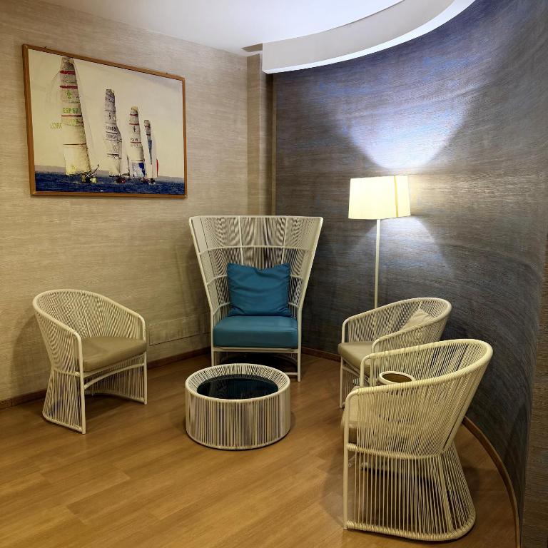 a waiting room with chairs and a blue chair at FAVIGNANA HOTEL Concept Holiday in Favignana