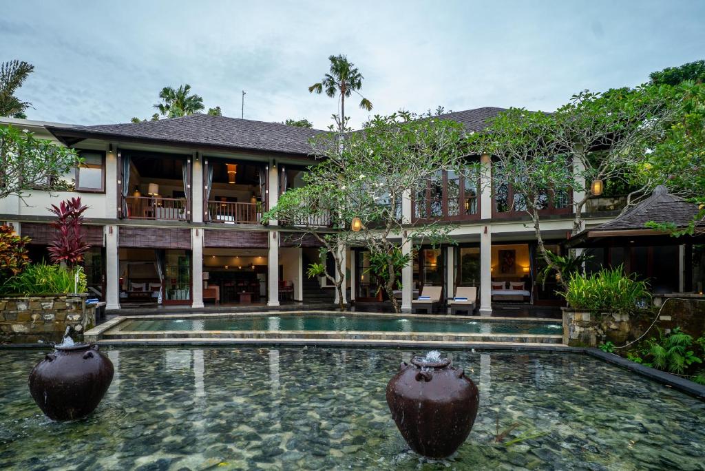 an exterior view of a house with a swimming pool at Villa Ambiente by Nakula in Jimbaran