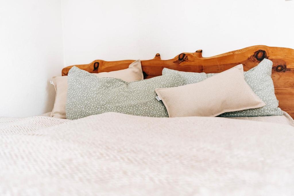 a bed with white sheets and pillows on it at Seetraum Steffi in Zoznegg
