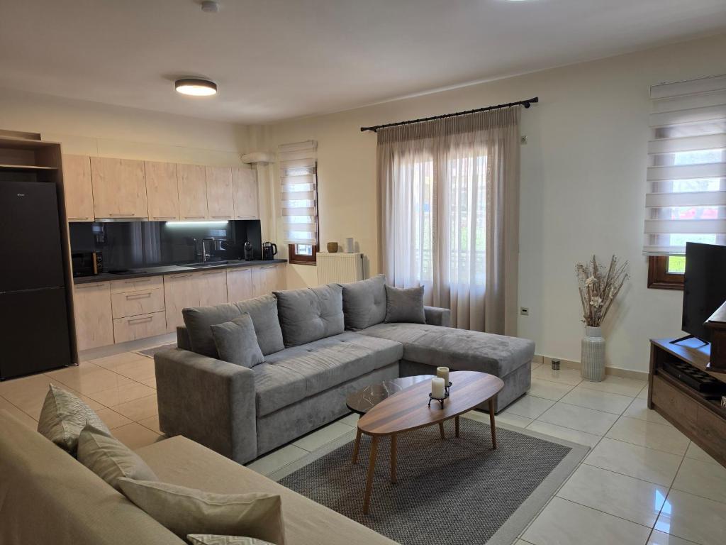 a living room with a couch and a table at Master Residence Lavrion in Lavrio