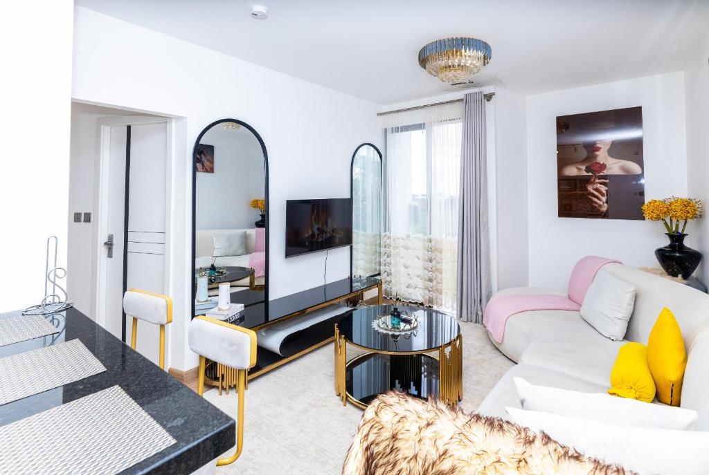 a living room with a white couch and a mirror at Snyder luxe homes 1 in Tatu City