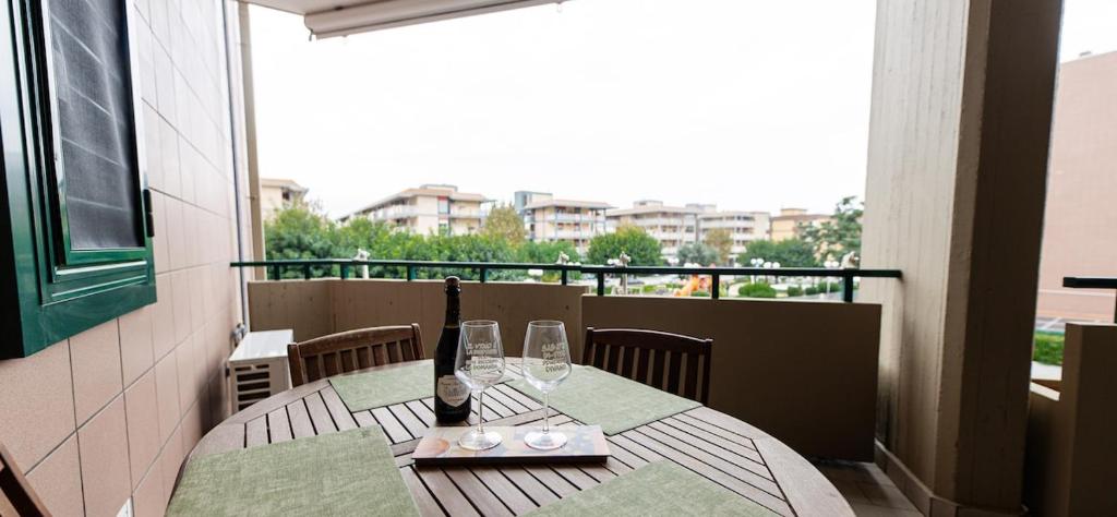 a table with wine glasses and a bottle on a balcony at Il Bergamotto in Bitritto