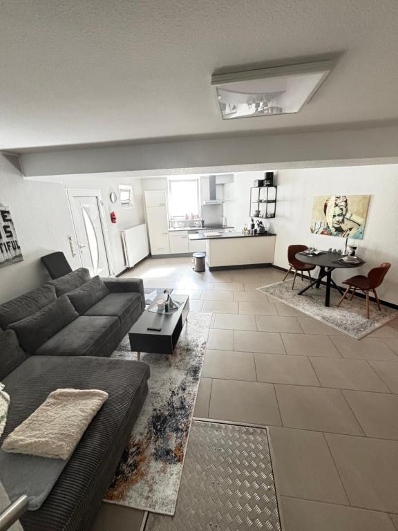 a living room with a couch and a table at Moderne und gemütliche Wohnung in Herzogenrath