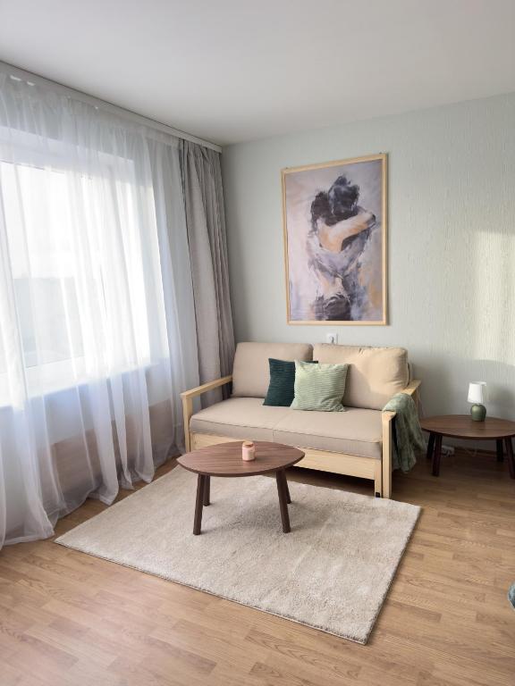 a living room with a couch and a table at Cozy 32 in Preiļi