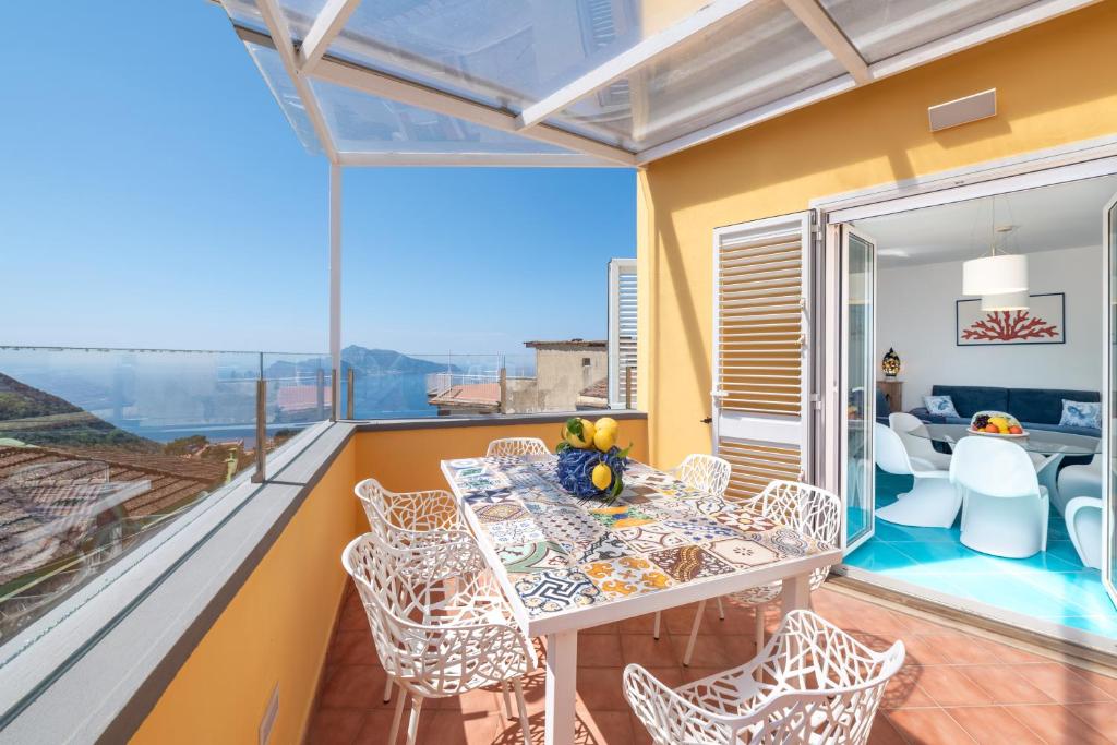 a dining room with a table and chairs on a balcony at Relais Miramar in Termini
