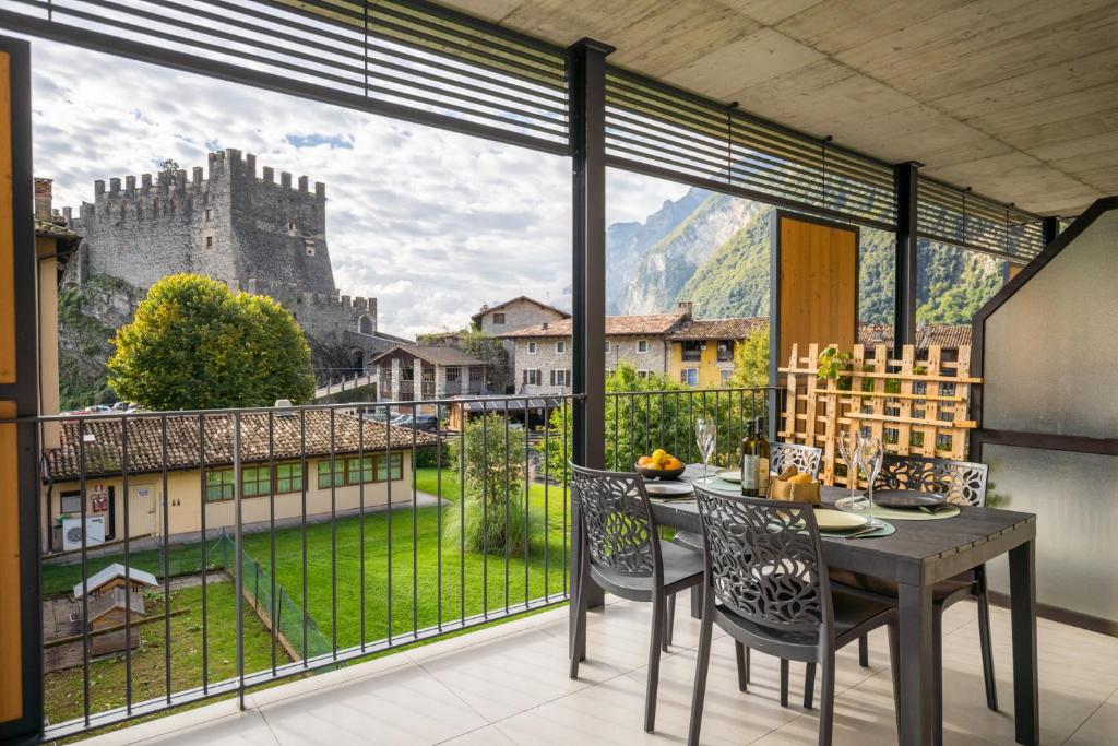 a dining room with a view of a castle at Castel View Apartment - Gardaslowemotion in Tenno