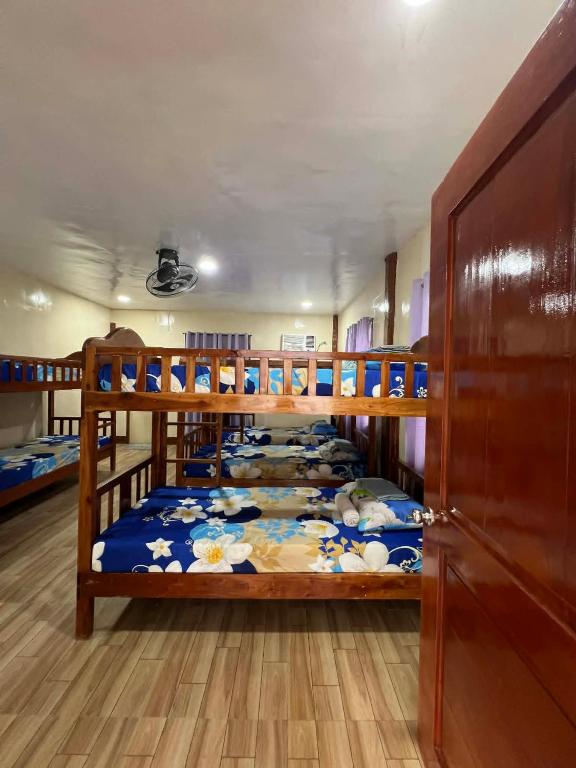 a bedroom with two bunk beds in a room at Gratum Beach Resort in Dapitan