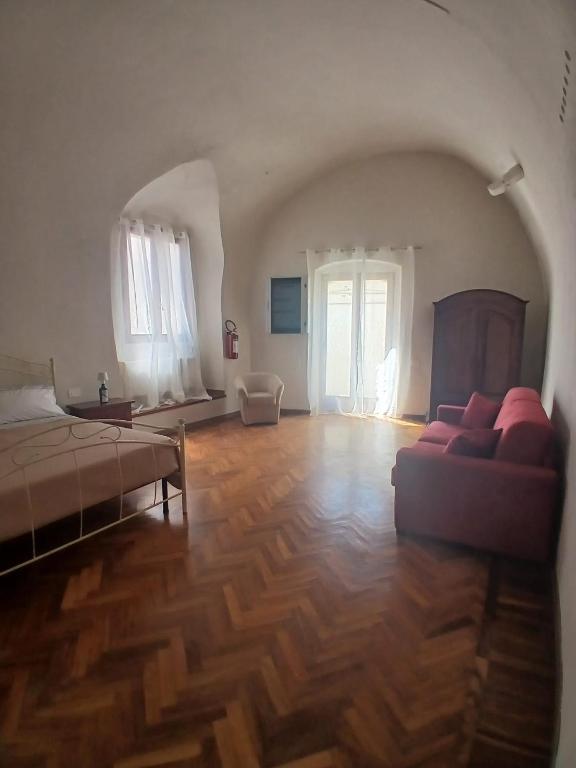 a living room with a couch and a bed at Tursi Relais Virtus in Tursi