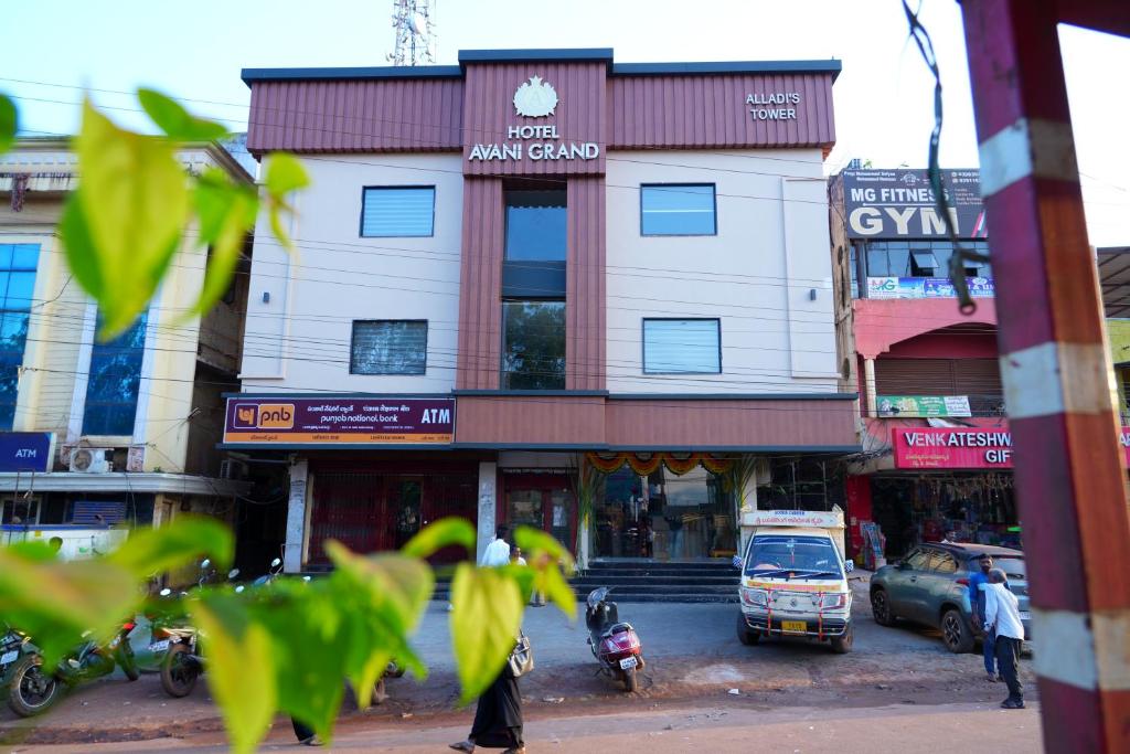 a building on the side of a city street at Hotel Avani Grand in Zahirābād