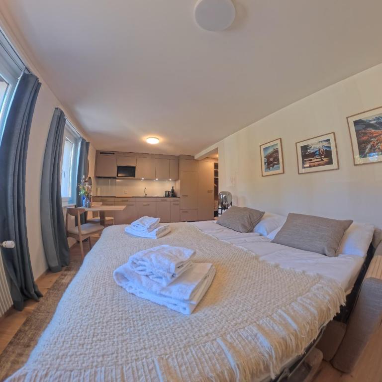 a large bed with towels on it in a room at Design-Studio nahe der Piste Lenzerheide in Lenzerheide