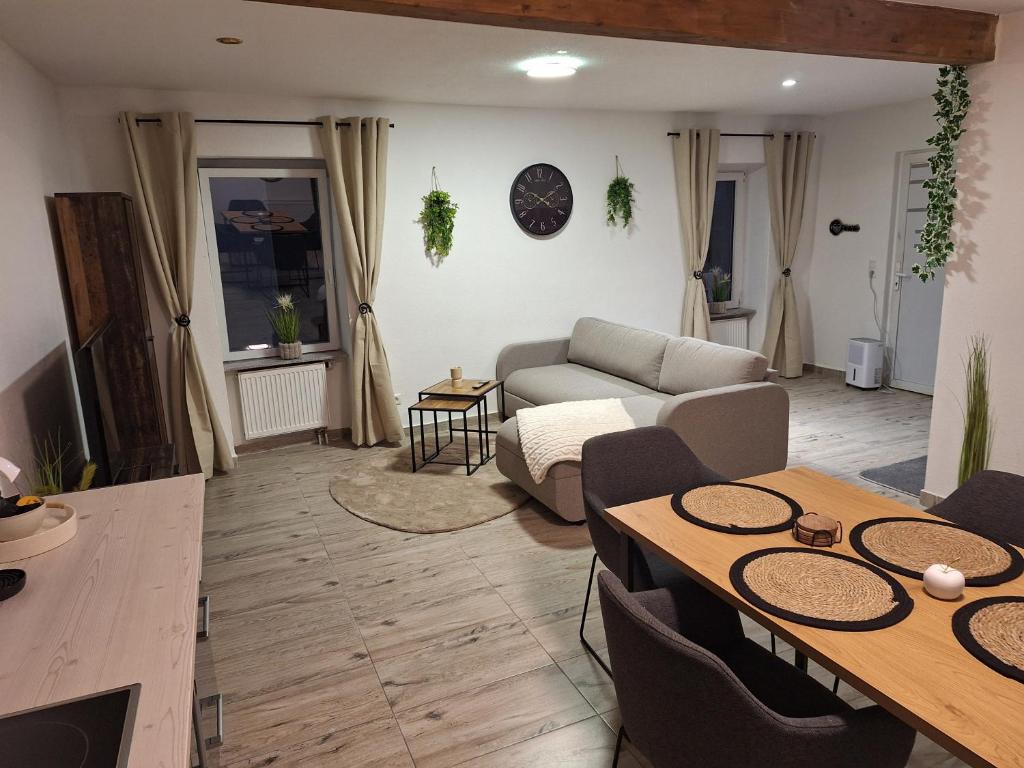 a living room with a couch and a table at Zum Feriennest in Ochtendung