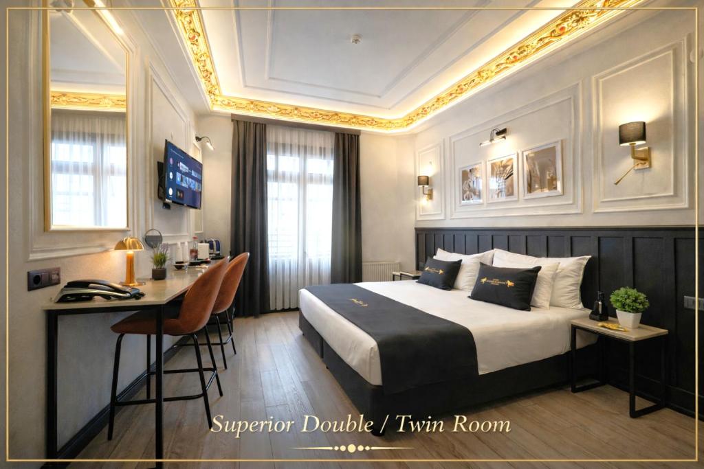 a hotel room with a bed and a desk at Angel's Home Suites - Angel Group Hotels in Istanbul