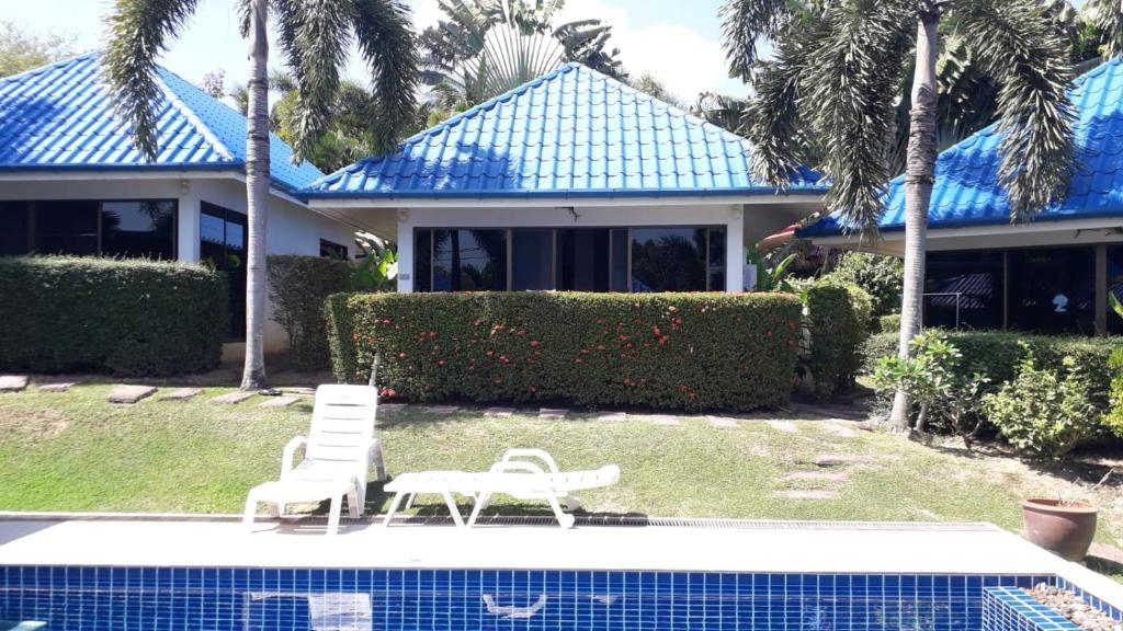 a house with two chairs and a swimming pool at bungalow with swimming pool in Rawai Beach