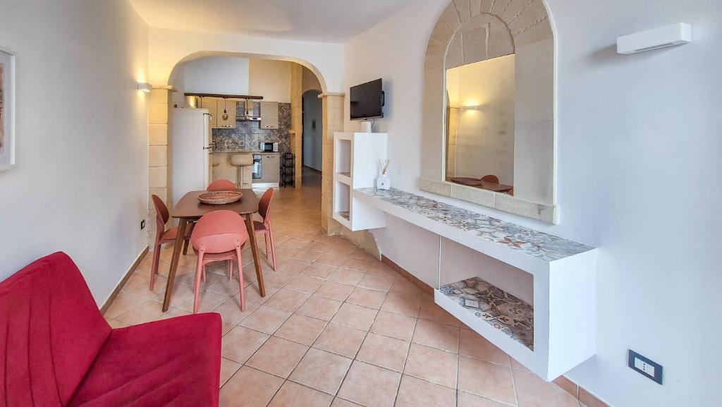 a kitchen and living room with a table and chairs at Galati House in Melendugno