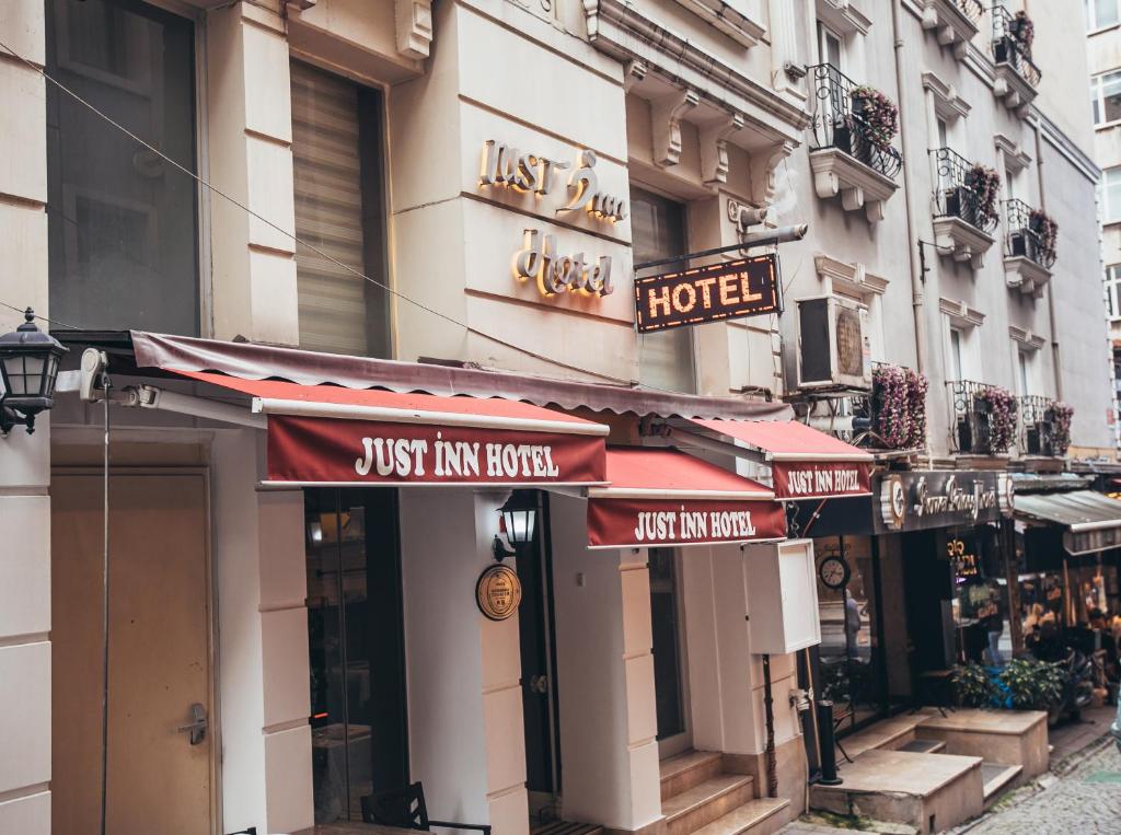 a store with red awnings on the side of a building at Just Inn Hotel in Istanbul