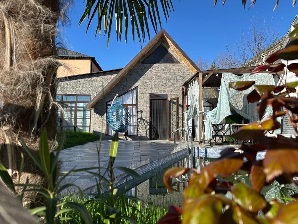 a house with a wooden deck in front of it at Firepalace Gabala in Gabala