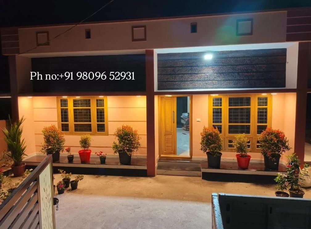 a building with potted plants in front of it at Star Varkala Homestay in Varkala